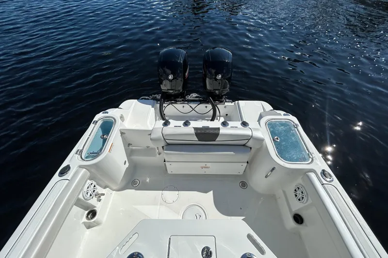 Slide: The Image of 2022 Wellcraft 242 Fisherman boat with dual engines on calm water. - 4