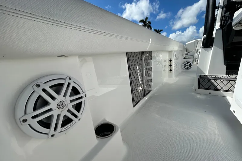 Slide: The Image of 2022 Wellcraft 242 Fisherman boat interior with JL Audio speaker and storage compartments. - 6