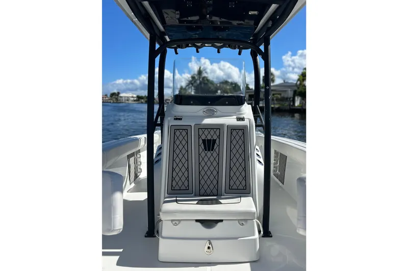 Slide: The Image of 2022 Wellcraft 242 Fisherman boat interior with console, on a sunny day by the water. - 8