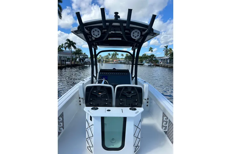 Slide: The Image of 2022 Wellcraft 242 Fisherman boat on a scenic waterway with palm trees. - 9