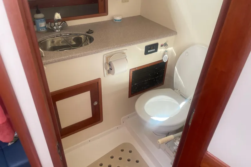 Slide: The Image of 1998 Little Harbor WhisperJet 36 boat on calm water at sunset. - 8