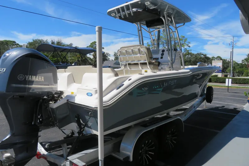 Slide: The Image of 2021 Key West 239 FS boat with Yamaha engine on trailer, parked outdoors. - 10