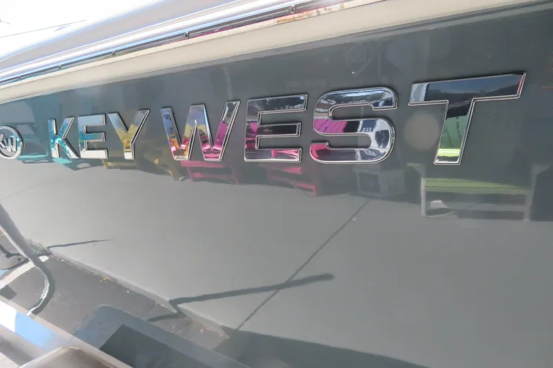 Slide: The Image of Key West 239 FS 2021 boat logo in reflective chrome finish. - 11