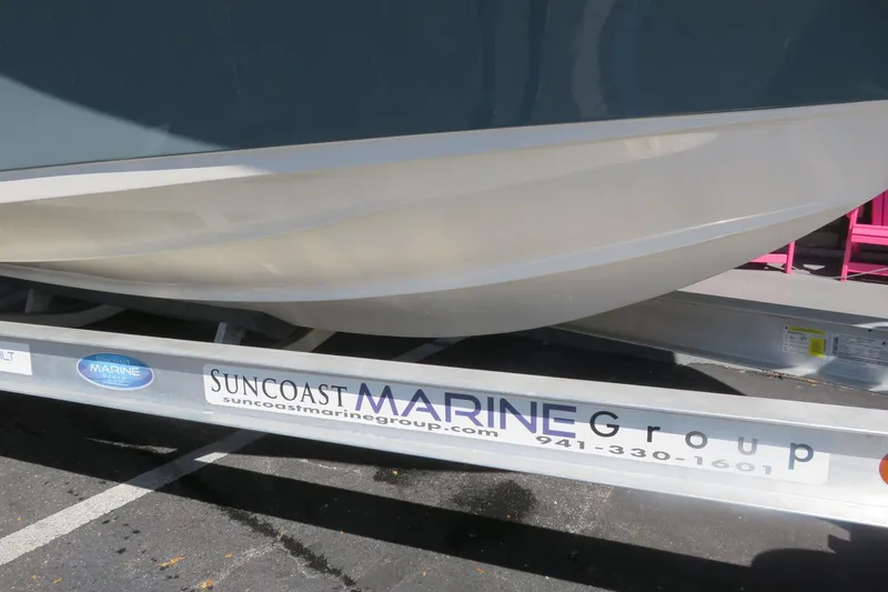 Slide: The Image of 2021 Key West 239 FS boat on Suncoast Marine Group trailer. - 12