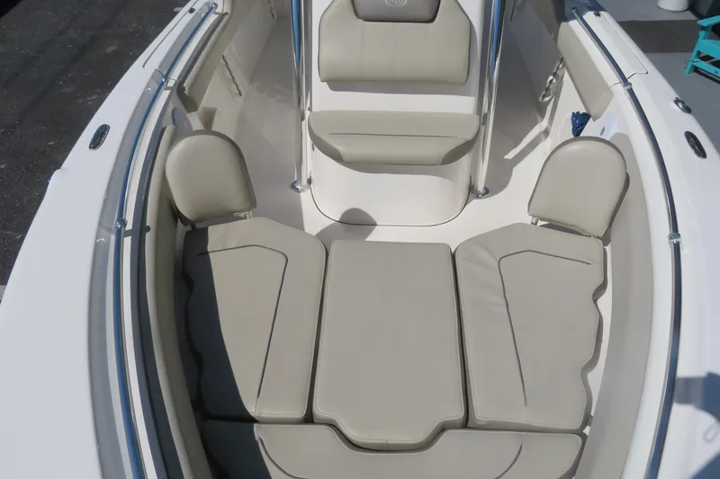 Slide: The Image of 2021 Key West 239 FS boat interior with cushioned seating and sleek design. - 13