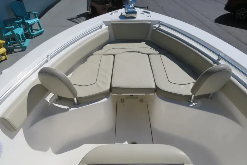 Slide: The Image of 2021 Key West 239 FS boat interior with cushioned seating and deck view. - 14