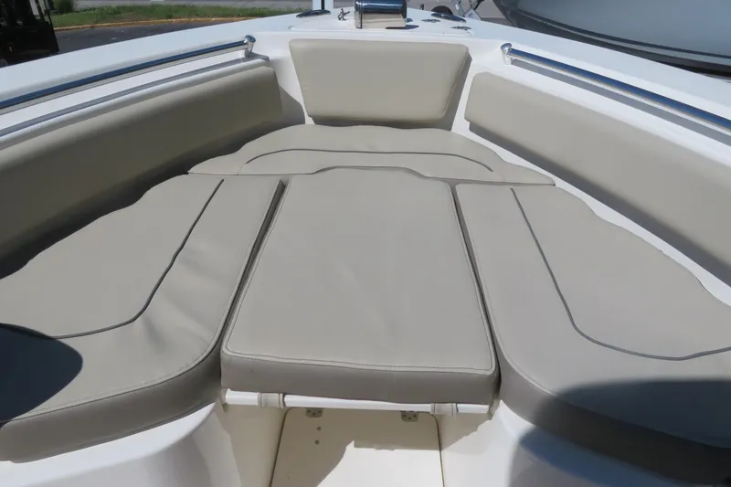 Slide: The Image of 2021 Key West 239 FS boat with cushioned seating in the bow area. - 15