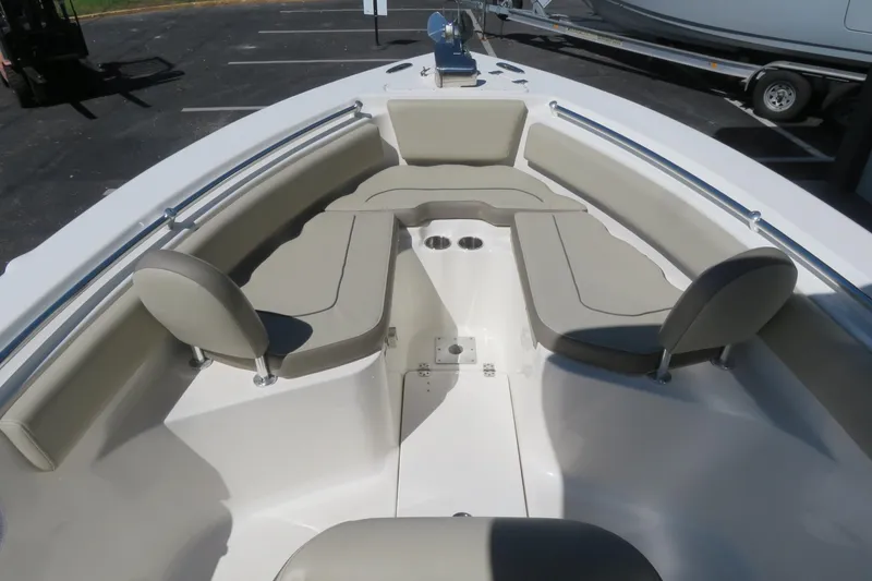 Slide: The Image of 2021 Key West 239 FS boat interior with cushioned seating and cup holders. - 16