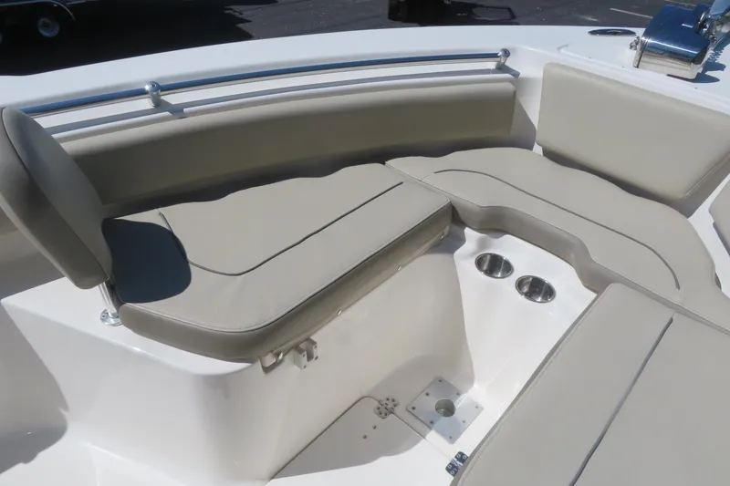 Slide: The Image of 2021 Key West 239 FS boat interior with cushioned seating and cup holders. - 17