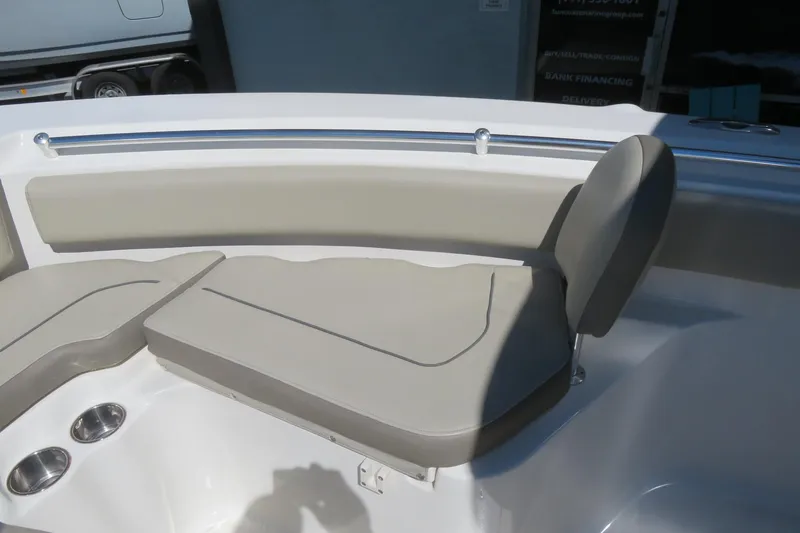 Slide: The Image of 2021 Key West 239 FS boat interior with cushioned seating and cup holders. - 18