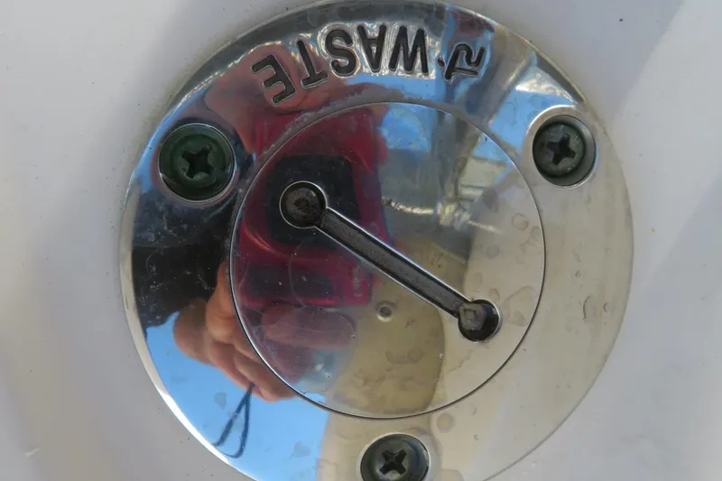 Slide: The Image of Close-up of a 2021 Key West 239 FS boat waste cap with screws. - 23