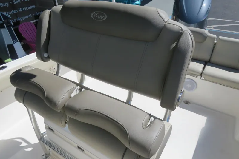 Slide: The Image of 2021 Key West 239 FS boat seating with beige upholstery and stainless steel frame. - 24
