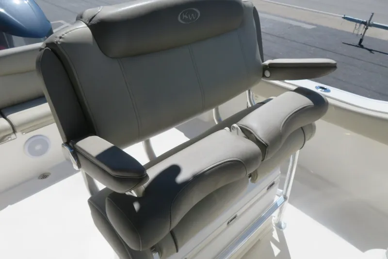 Slide: The Image of 2021 Key West 239 FS boat seat with cushioned armrests and sleek design. - 25