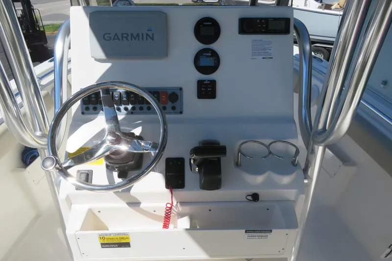 Slide: The Image of 2021 Key West 239 FS boat dashboard with Garmin navigation system and steering wheel. - 32