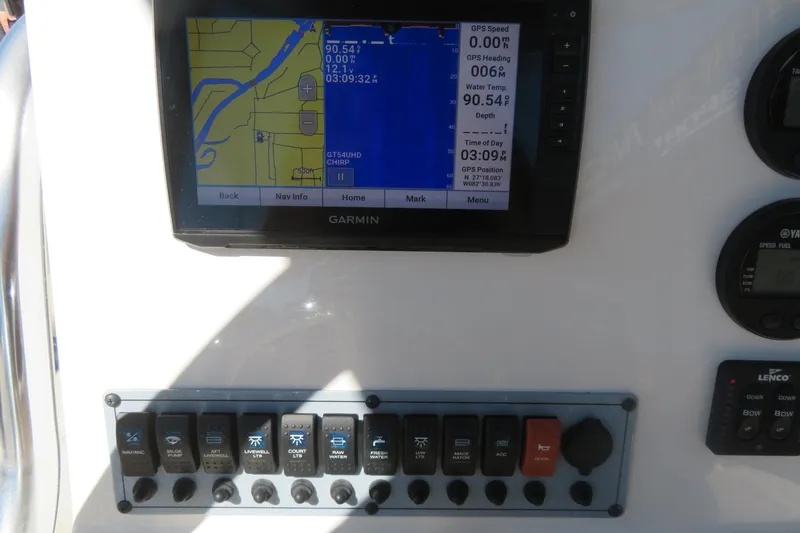 Slide: The Image of Garmin GPS display on 2021 Key West 239 FS boat dashboard with control switches. - 33