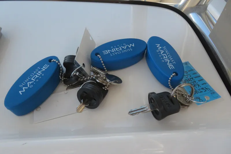 Slide: The Image of Boat keys with blue Suncoast Marine Group floats on a Key West 239 FS, 2021 model. - 35