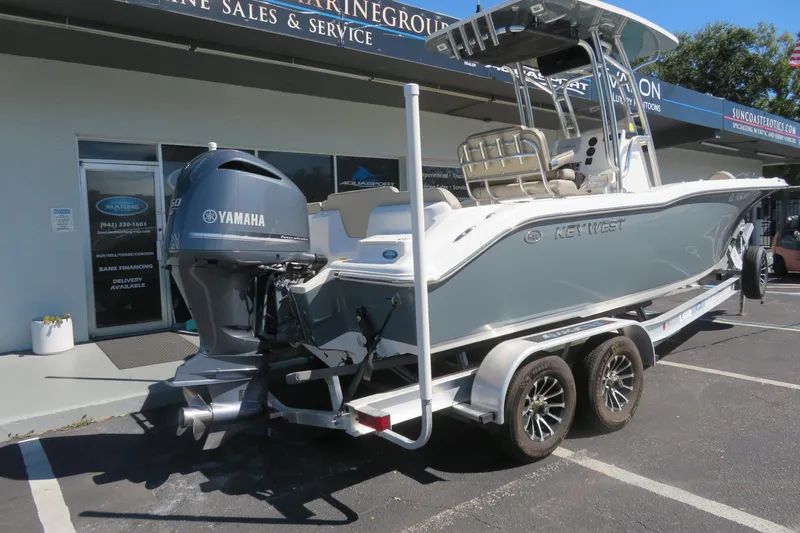 Slide: The Image of 2021 Key West 239 FS boat with Yamaha engine on a trailer outside a marine dealership. - 4