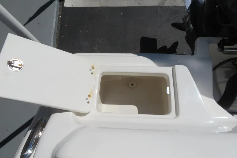 Slide: The Image of 2021 Key West 239 FS boat storage compartment with open lid, showcasing interior space. - 46