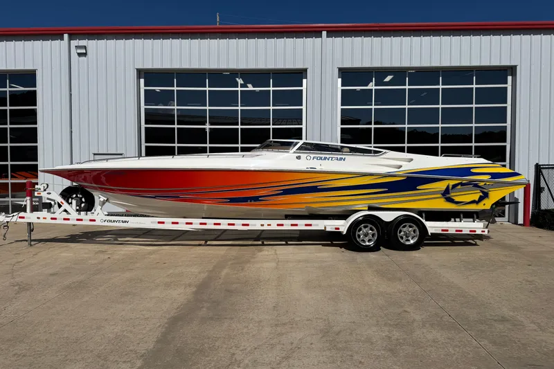 Slide: The Image of 2008 Fountain 35 Lightning speedboat with vibrant red and yellow graphics on a trailer. - 1