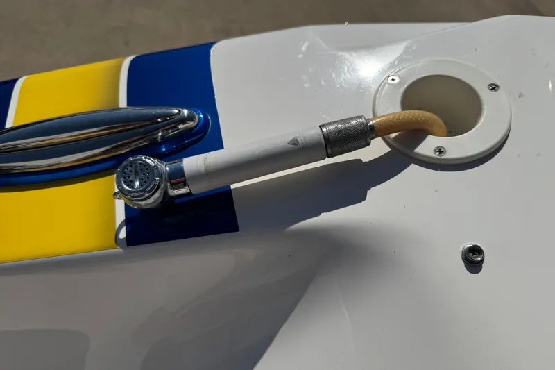 Slide: The Image of 2008 Fountain 35 Lightning boat detail with colorful stripes and hose connection. - 10