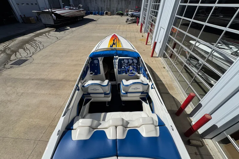 Slide: The Image of 2008 Fountain 35 Lightning boat with blue and white interior, parked near a garage. - 12