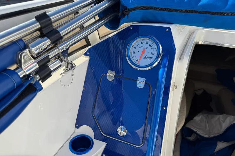 Slide: The Image of 2008 Fountain 35 Lightning boat interior with blue accents and speedometer. - 14