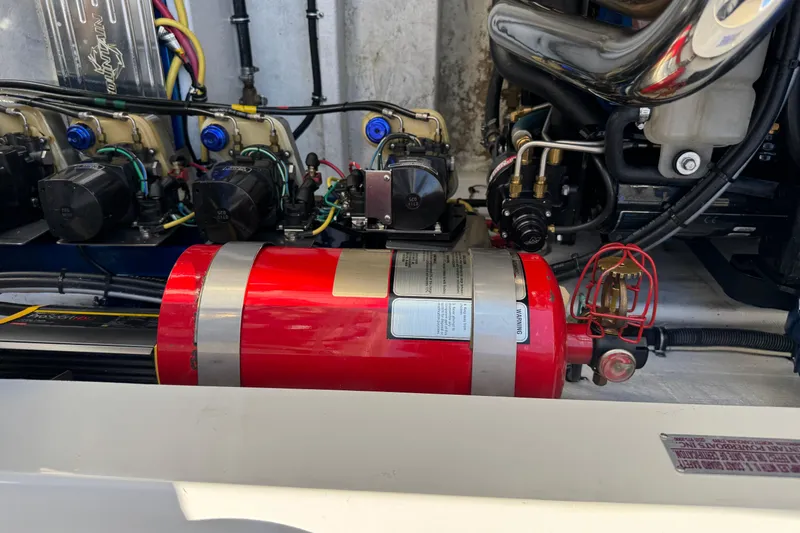 Slide: The Image of Engine compartment of a 2008 Fountain 35 Lightning boat, featuring mechanical components and wiring. - 20