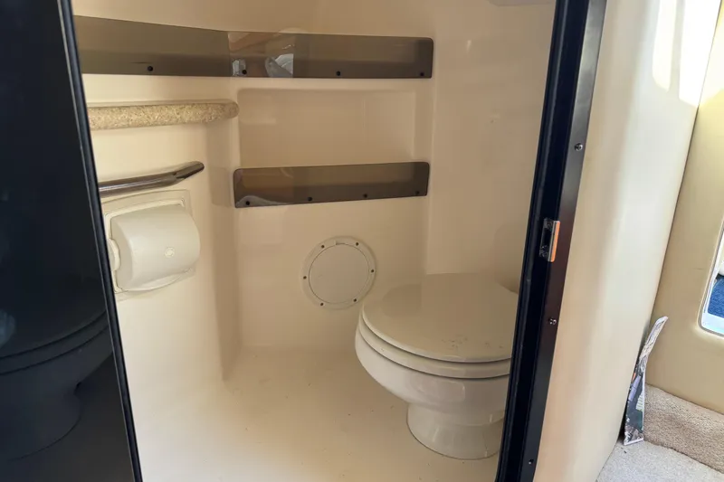 Slide: The Image of 2008 Fountain 35 Lightning boat bathroom interior with toilet and storage shelves. - 21