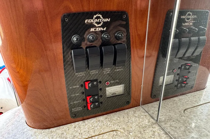 Slide: The Image of Control panel of a 2008 Fountain 35 Lightning boat with switches and gauges. - 28