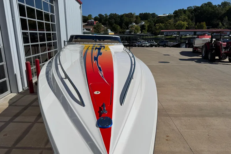 Slide: The Image of 2008 Fountain 35 Lightning boat with vibrant graphics, parked outdoors on a sunny day. - 3