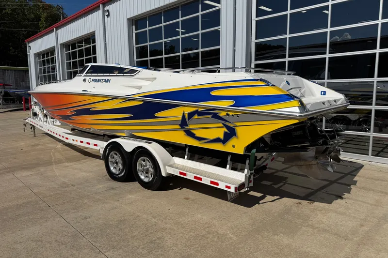 Slide: The Image of 2008 Fountain 35 Lightning boat with vibrant yellow and blue graphics on a trailer. - 5