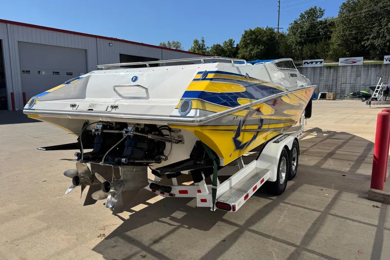 Slide: The Image of 2008 Fountain 35 Lightning speedboat with vibrant yellow and blue graphics on a trailer. - 6