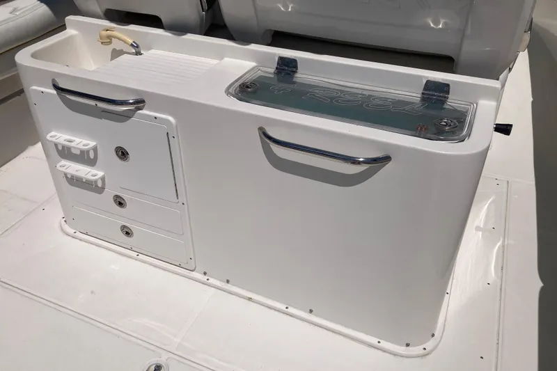 Slide: The Image of 2016 Tarpon 326 boat console with storage compartments and sink. - 11