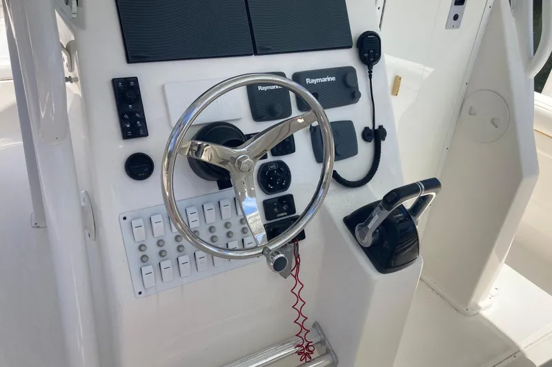 Slide: The Image of 2016 Tarpon 326 boat dashboard with steering wheel and control panel. - 12