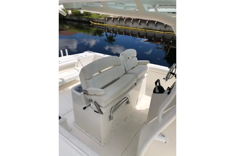 Slide: The Image of 2016 Tarpon 326 boat interior with white seating and steering wheel. - 19