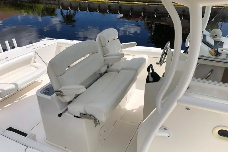 Slide: The Image of 2016 Tarpon 326 boat interior with white cushioned seating and steering wheel. - 24