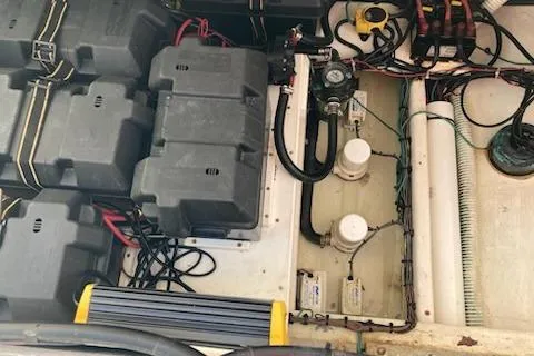 Slide: The Image of 2016 Stamas 326 Tarpon boat engine compartment with batteries and wiring. - 31