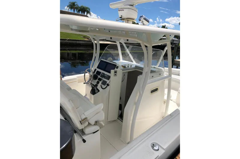 Slide: The Image of 2016 Tarpon 326 boat cockpit with steering wheel, controls, and navigation equipment. - 16