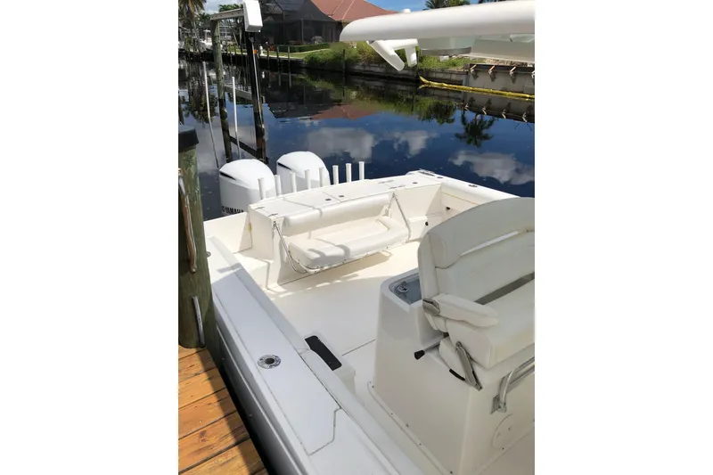 Slide: The Image of 2016 Tarpon 326 boat with dual Yamaha engines docked by a calm canal. - 20