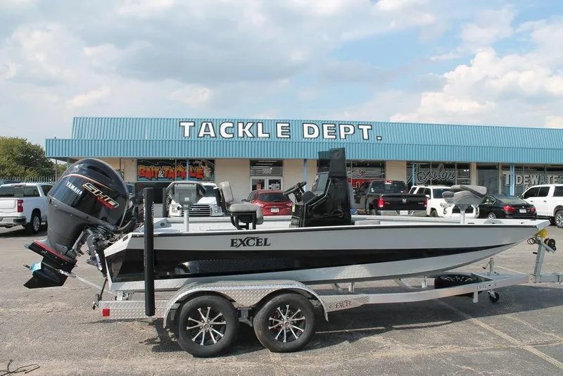 The Image of 2026 Excel Bay Pro Elite 203 boat on trailer outside tackle shop. - 0