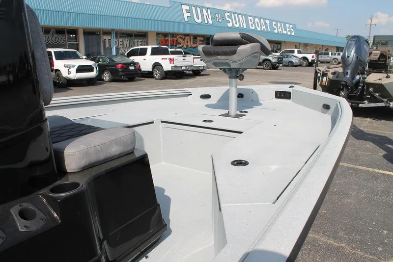 Slide: The Image of 2026 Excel Bay Pro Elite 203 boat at dealership, showcasing spacious deck and seating. - 11