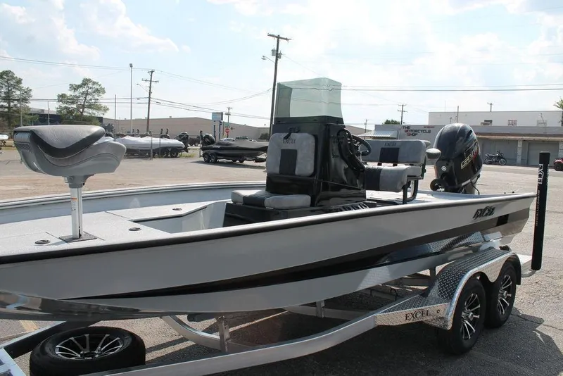 Slide: The Image of 2026 Excel Bay Pro Elite 203 boat on trailer, parked outdoors, featuring sleek design and modern equipment. - 2