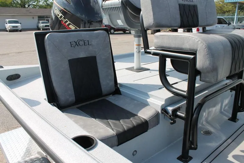 Slide: The Image of 2026 Excel Bay Pro Elite 203 boat interior with cushioned seating and motor. - 9