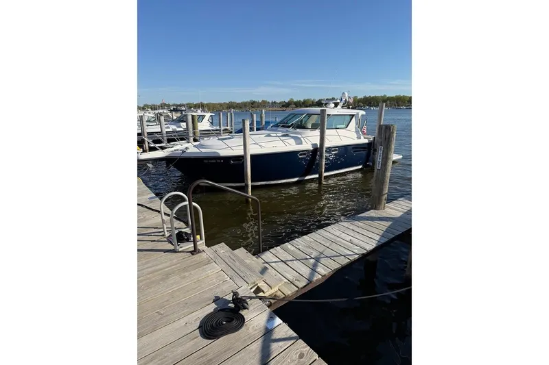 The Image of 2006 Tiara Yachts 4400 Sovran docked at a marina on a sunny day. - 0