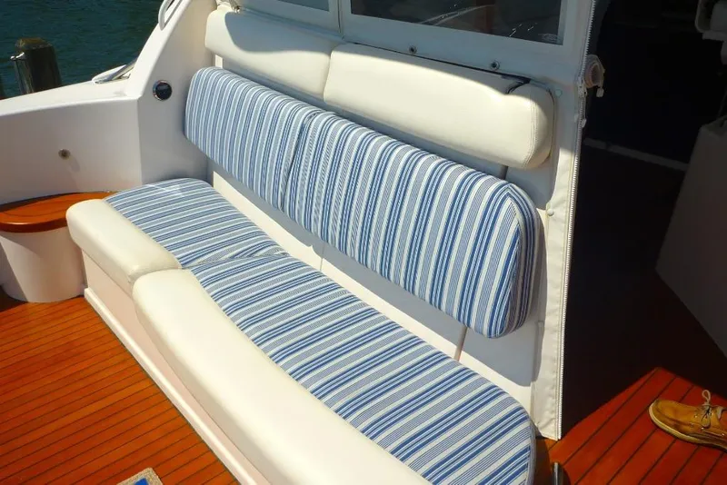 Slide: The Image of 2006 Tiara 44' Sovran yacht with striped seating and wooden deck. - 11