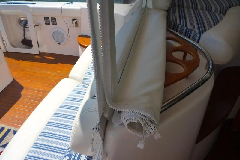 Slide: The Image of Interior of 2006 Tiara 44' Sovran yacht with striped seating and wooden accents. - 12