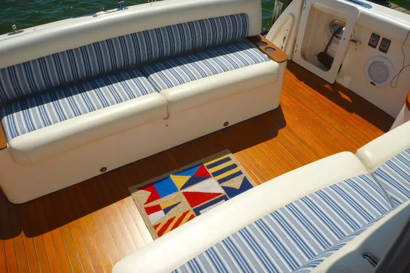 Slide: The Image of 2006 Tiara 44' Sovran yacht interior with striped seating and colorful rug. - 13