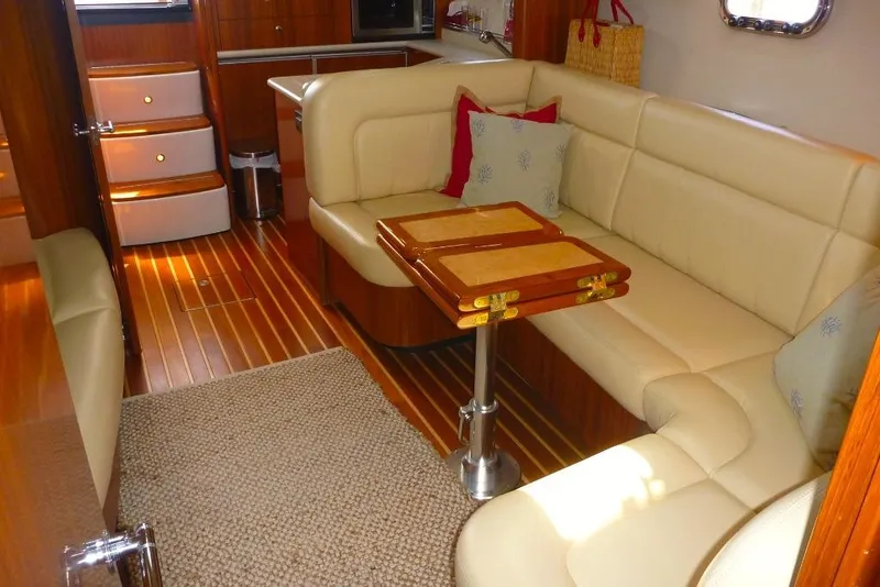 Slide: The Image of Luxurious interior of 2006 Tiara 44' Sovran yacht with beige seating and wooden accents. - 19