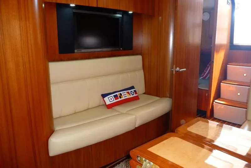 Slide: The Image of Interior of 2006 Tiara 44' Sovran yacht with beige seating and wall-mounted TV. - 20