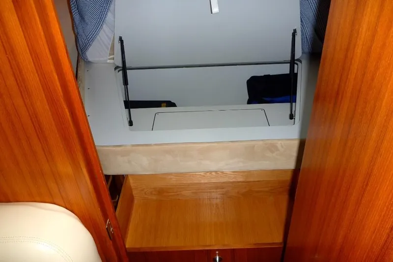 Slide: The Image of 2006 Tiara 44' Sovran interior with wooden cabinetry and storage compartment. - 24